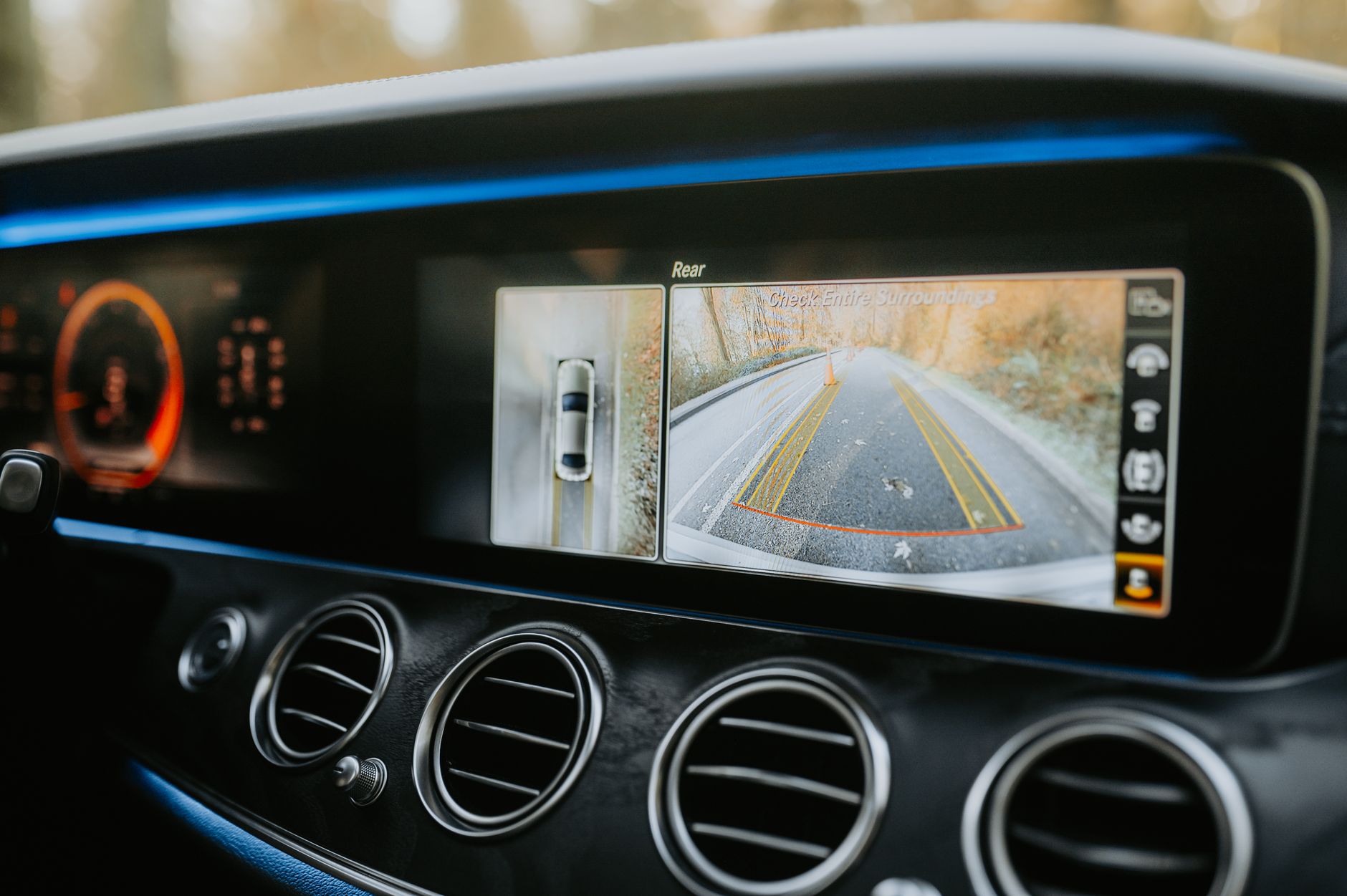 Close-up of a car dashboard showcasing a rear-view camera display and modern electronics. — Refer a Friend to Jeetwin and Ear