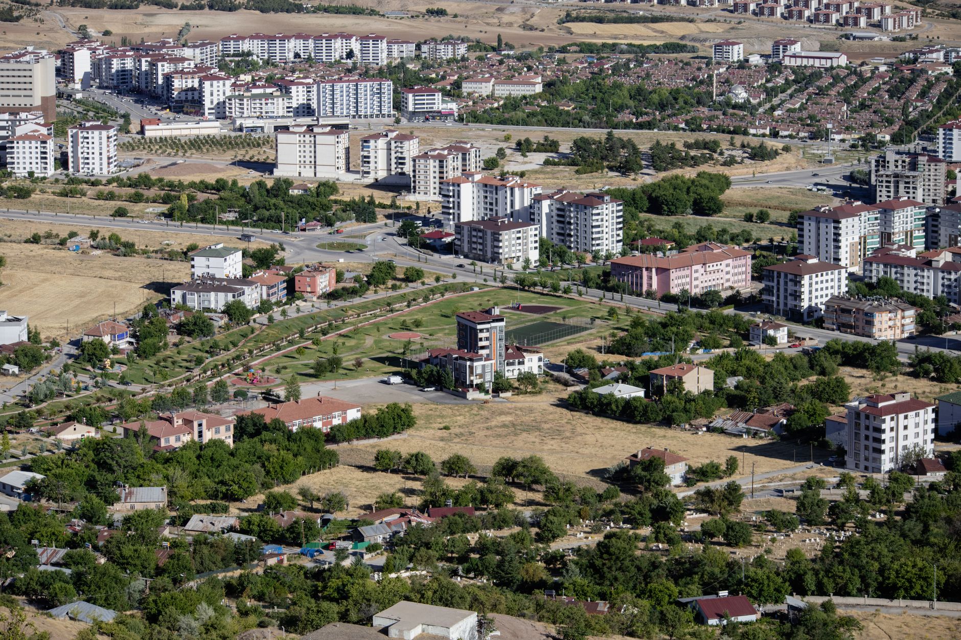 Aerial cityscape of Elâzığ, Türkiye showcasing apartments and greenery in summer. — The Role of Bitcoin in the Financial Cris